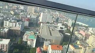 Bikini model lounges by the pool on Pattaya's rooftops