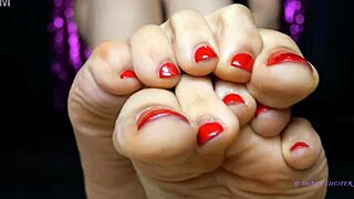 sweat small feet mistress applies red toenail polish in female domination sensual setting