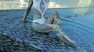 Bikini model lounges by the pool on Pattaya's rooftops