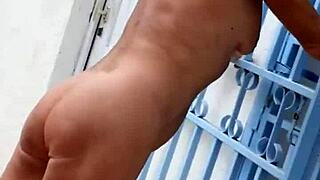 Mature blonde struts nude in heels through the garden flashing shaved pussy