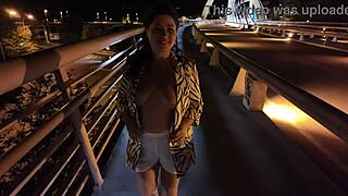 Luscious curvy MILF struts bridge flashing huge natural tits big ass no bra panties hairy pussy.