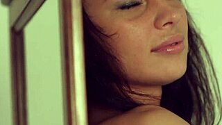 dark haired teen undresses gropes shaved pussy in mirror