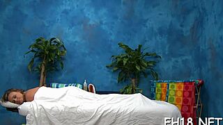  masseuse glides hands over client's tense body in intimate session