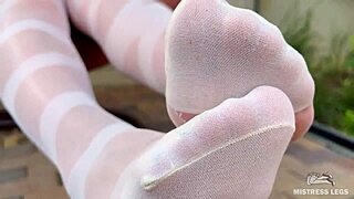 Enjoy seductive nylon feet on a bench in pantyhose