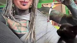 narrative tattooed girl plays with her kitten